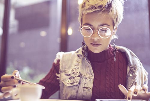 Girl at coffee shop looking at tablet